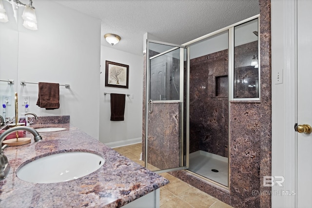 6417 Magnolia Place Ct, Mobile, AL 36695 - full bathroom with a stall shower, tile patterned floors, double vanity, a textured ceiling, and baseboards