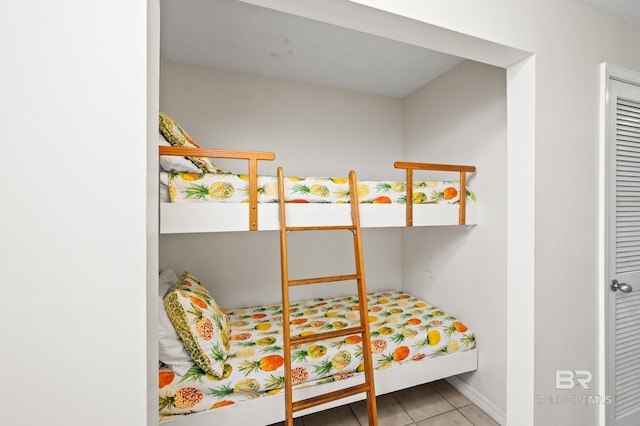 bedroom with tile patterned flooring and baseboards