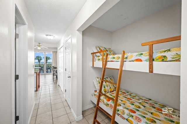 hallway with light tile patterned floors and baseboards