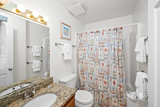 full bathroom with toilet, curtained shower, a textured ceiling, and vanity