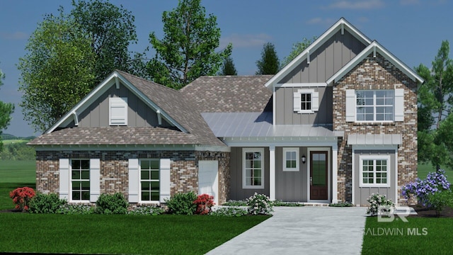 craftsman-style home with a front lawn, brick siding, board and batten siding, and roof with shingles