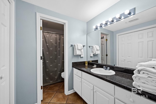 bathroom with tile patterned flooring, vanity, toilet, and a shower with shower curtain