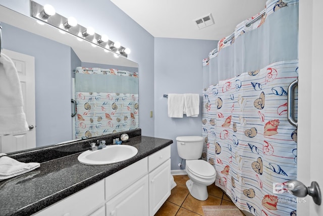 bathroom featuring tile patterned floors, vanity, and toilet