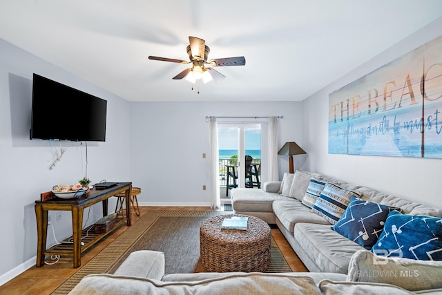 living room with ceiling fan and tile patterned flooring