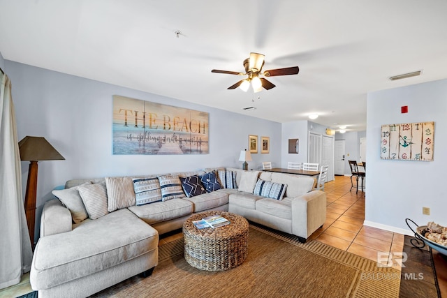 tiled living room with ceiling fan