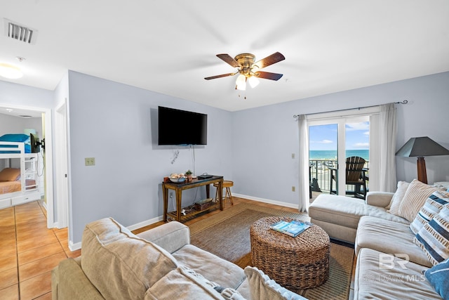 tiled living room featuring ceiling fan