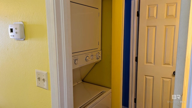 laundry room featuring stacked washer / dryer