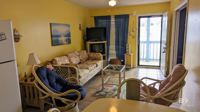 living room featuring ceiling fan and light tile patterned floors