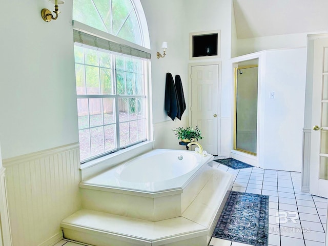 bathroom with tile patterned floors, lofted ceiling, and shower with separate bathtub