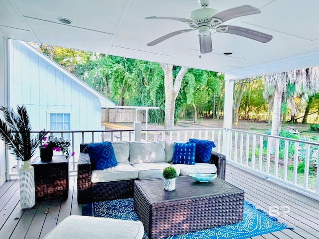 deck with an outdoor living space and ceiling fan