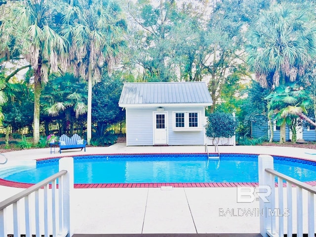 view of pool with a patio area and an outdoor structure