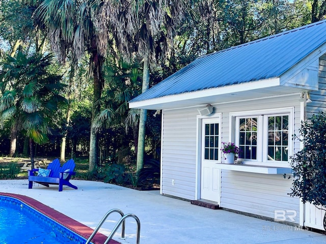 view of swimming pool with a patio area and an outdoor structure