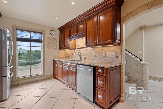 28452 Ono Blvd, Orange Beach, AL 36561 - kitchen featuring stainless steel appliances, light tile patterned flooring, backsplash, light stone countertops, and recessed lighting