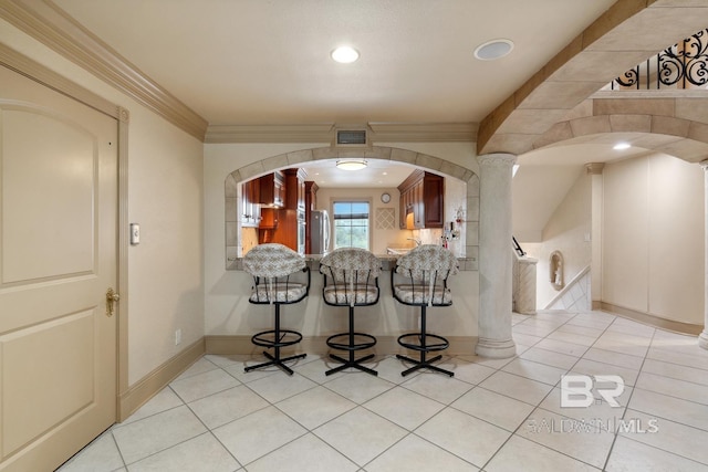 28452 Ono Blvd, Orange Beach, AL 36561 - interior space featuring crown molding, freestanding refrigerator, arched walkways, and recessed lighting