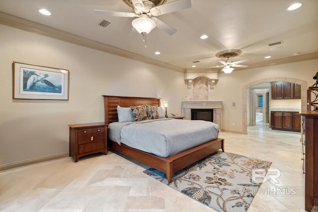 28452 Ono Blvd, Orange Beach, AL 36561 - bedroom with recessed lighting, arched walkways, crown molding, ceiling fan, and a large fireplace