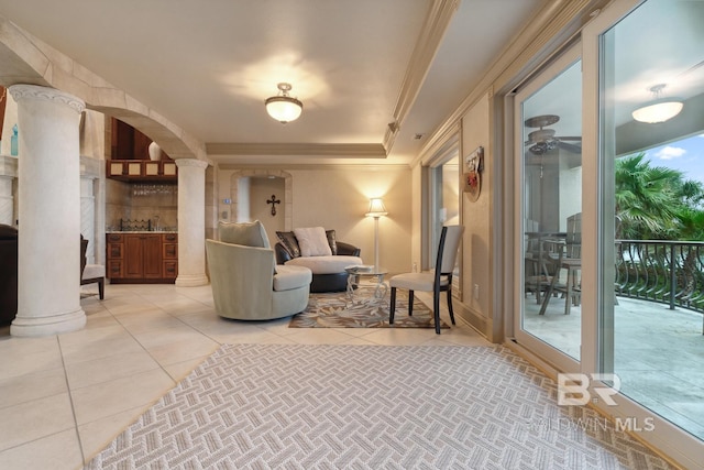28452 Ono Blvd, Orange Beach, AL 36561 - tiled living room with decorative columns, arched walkways, crown molding, and ceiling fan