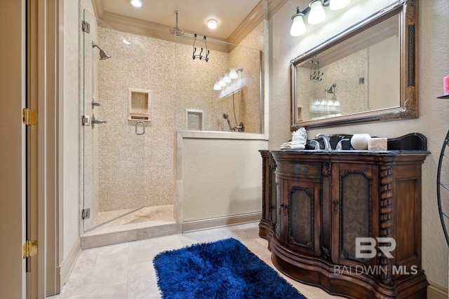 28452 Ono Blvd, Orange Beach, AL 36561 - bathroom featuring a tile shower, vanity, ornamental molding, and tile patterned floors