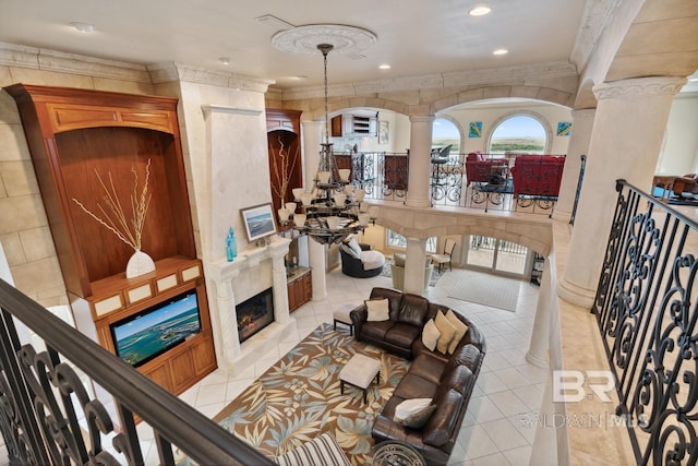 28452 Ono Blvd, Orange Beach, AL 36561 - living area with ornate columns, ornamental molding, a premium fireplace, recessed lighting, and light tile patterned floors