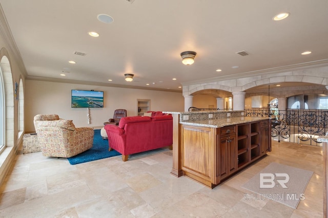 28452 Ono Blvd, Orange Beach, AL 36561 - kitchen featuring crown molding, recessed lighting, brown cabinetry, open floor plan, and light stone counters