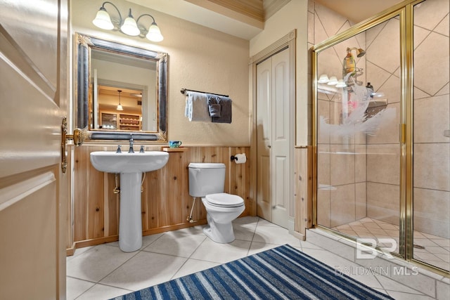 28452 Ono Blvd, Orange Beach, AL 36561 - bathroom with a shower stall, wainscoting, and tile patterned floors