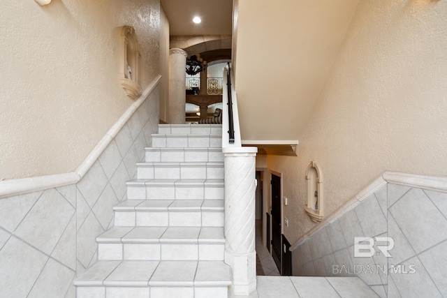 28452 Ono Blvd, Orange Beach, AL 36561 - staircase with tile walls and wainscoting