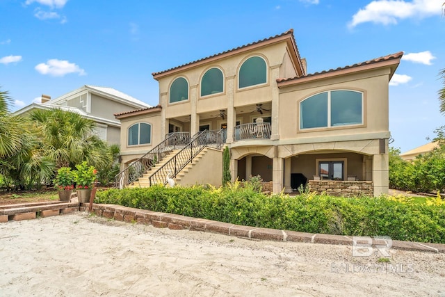28452 Ono Blvd, Orange Beach, AL 36561 - back of house with ceiling fan, stairway, and stucco siding