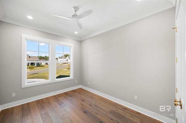 empty room featuring hardwood / wood-style flooring, ceiling fan, and crown molding