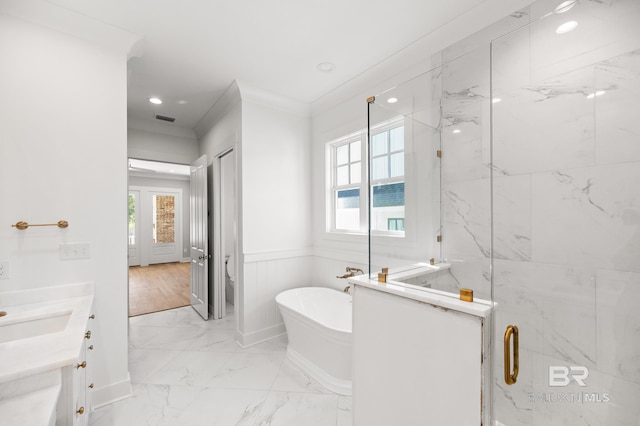 bathroom featuring ornamental molding, vanity, and independent shower and bath