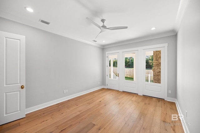 spare room with ceiling fan, crown molding, and light wood-type flooring