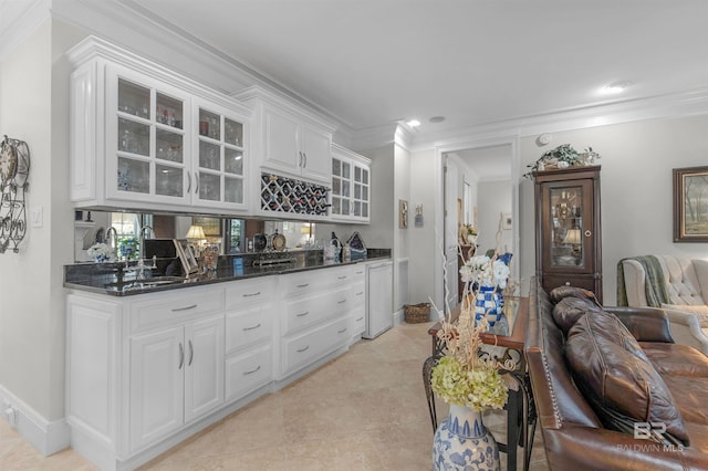 bar with baseboards, ornamental molding, and light tile patterned floors