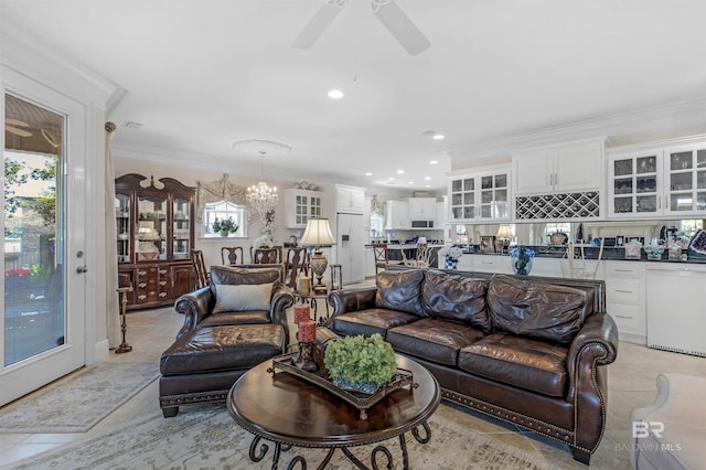 living area with light tile patterned floors, ornamental molding, ceiling fan with notable chandelier, and recessed lighting