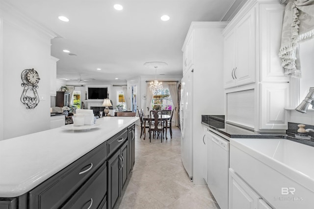 kitchen with white cabinetry, recessed lighting, ornamental molding, a sink, and dishwasher