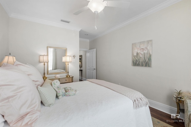 bedroom with ornamental molding, baseboards, visible vents, ceiling fan, and wood finished floors