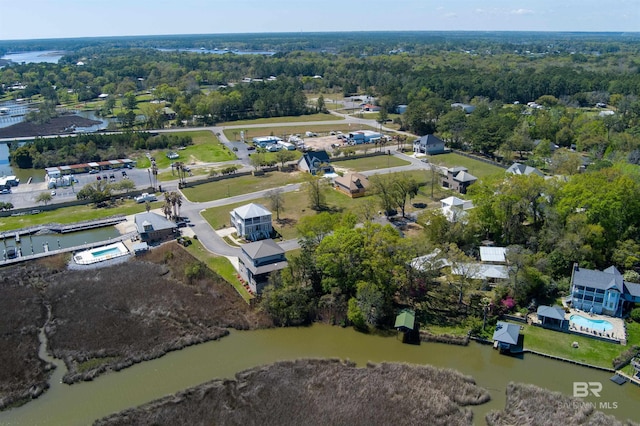 bird's eye view with a water view and a wooded view