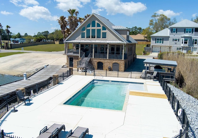 pool featuring stairway, fence, and a patio