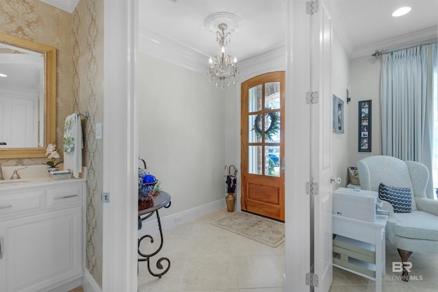 foyer entrance featuring light tile patterned floors, crown molding, baseboards, and a chandelier