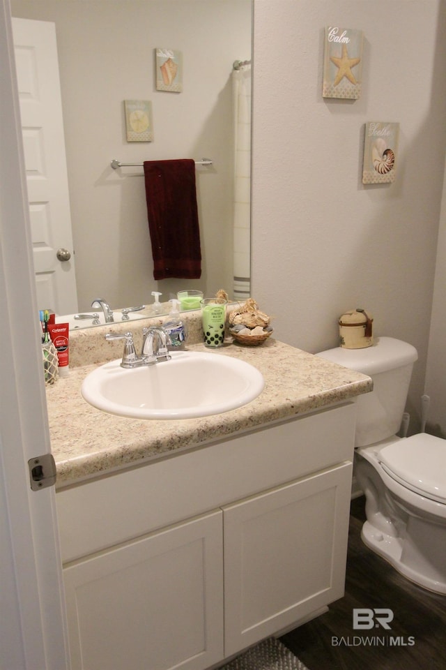 bathroom featuring vanity and toilet