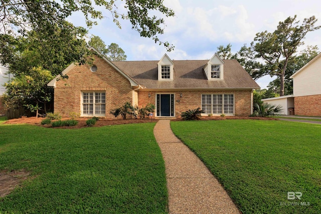 cape cod-style house with a front yard