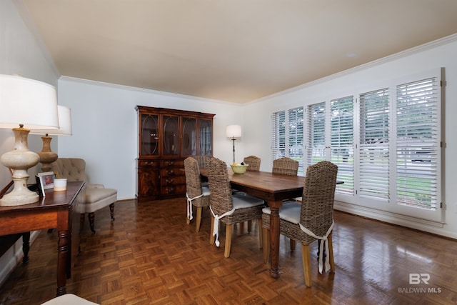 dining room with dark parquet flooring, a healthy amount of sunlight, and ornamental molding