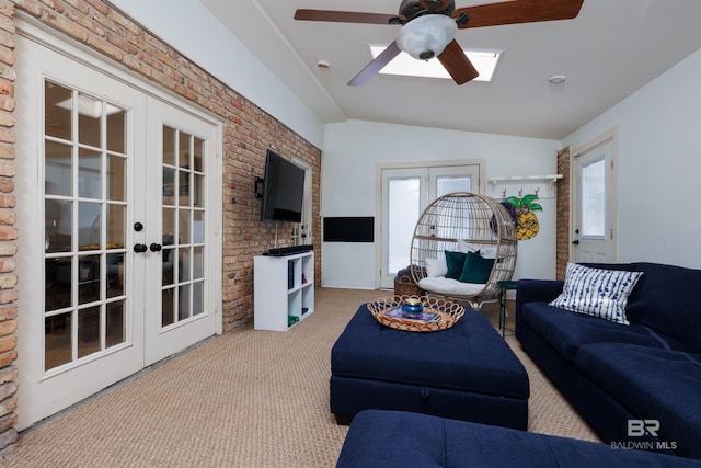 living room featuring ceiling fan, french doors, brick wall, and lofted ceiling