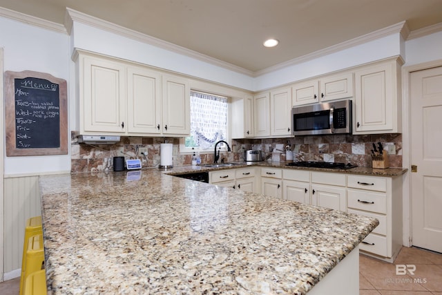 kitchen with black gas stovetop, sink, decorative backsplash, light stone countertops, and light tile patterned floors