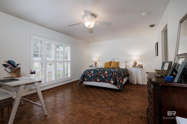 bedroom with ceiling fan and dark parquet floors