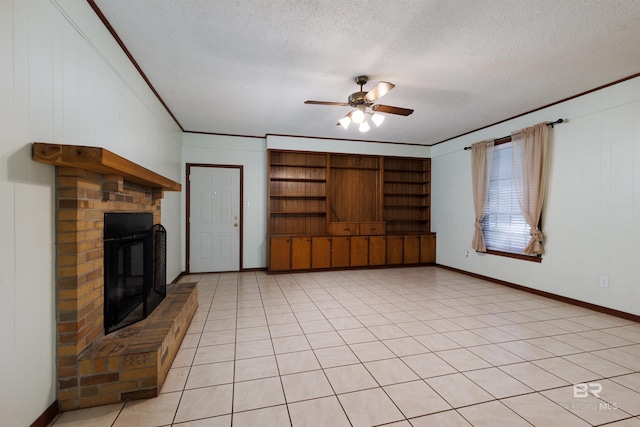 unfurnished living room featuring light tile patterned floors, crown molding, a textured ceiling, a brick fireplace, and ceiling fan