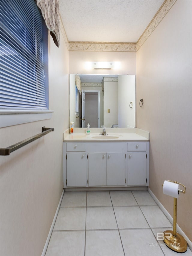 bathroom with tile patterned flooring, vanity, and a textured ceiling