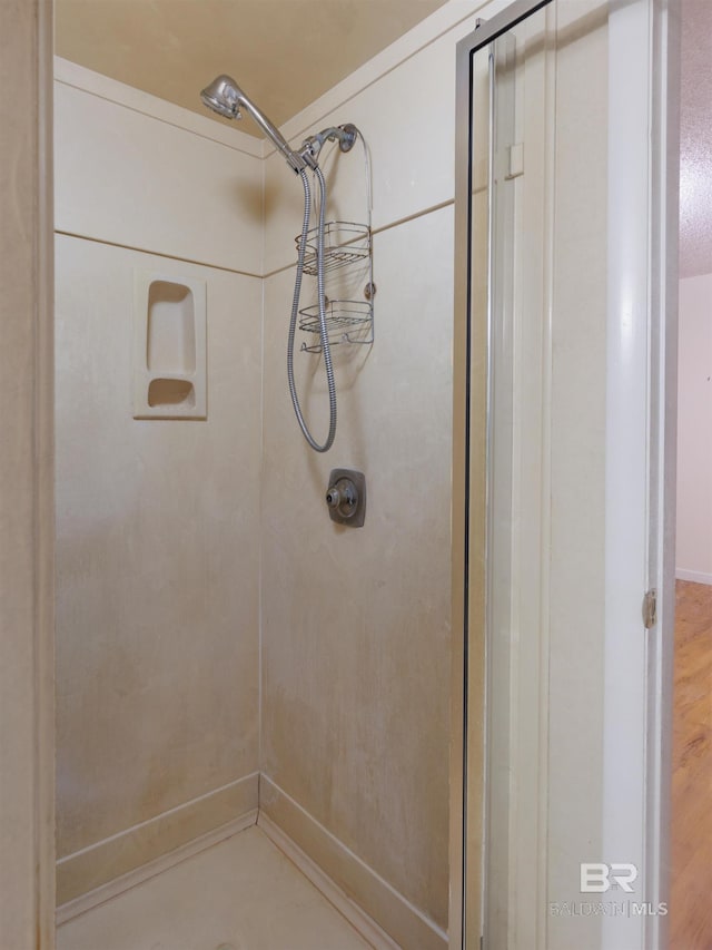 bathroom featuring walk in shower and hardwood / wood-style floors