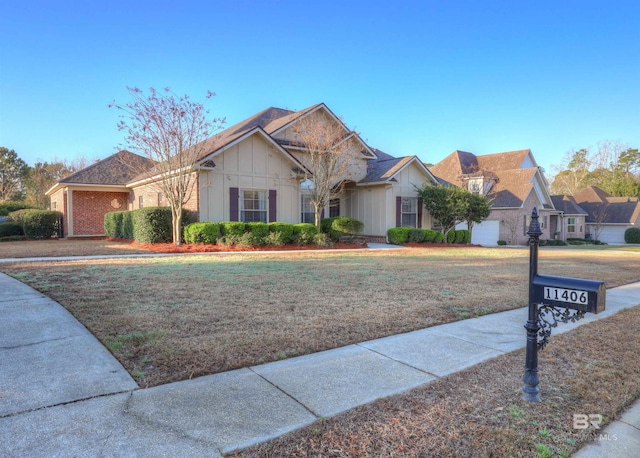 single story home featuring brick siding and a front lawn