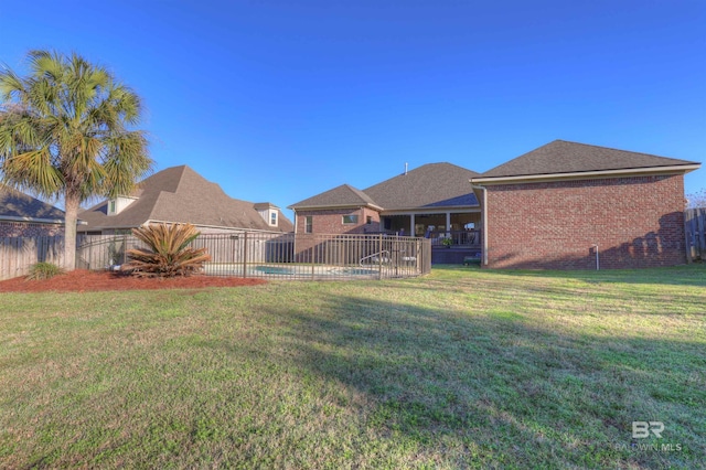 view of yard featuring a fenced in pool and fence