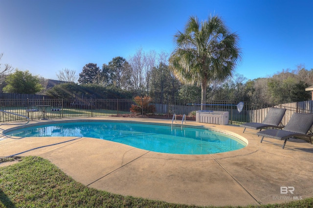 view of swimming pool with a fenced in pool, a patio, and fence