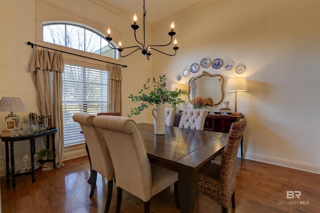 dining area with an inviting chandelier, wood finished floors, and baseboards