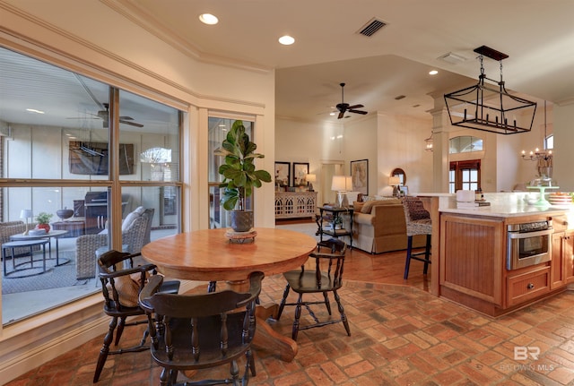 dining area featuring visible vents, crown molding, ceiling fan, recessed lighting, and brick floor